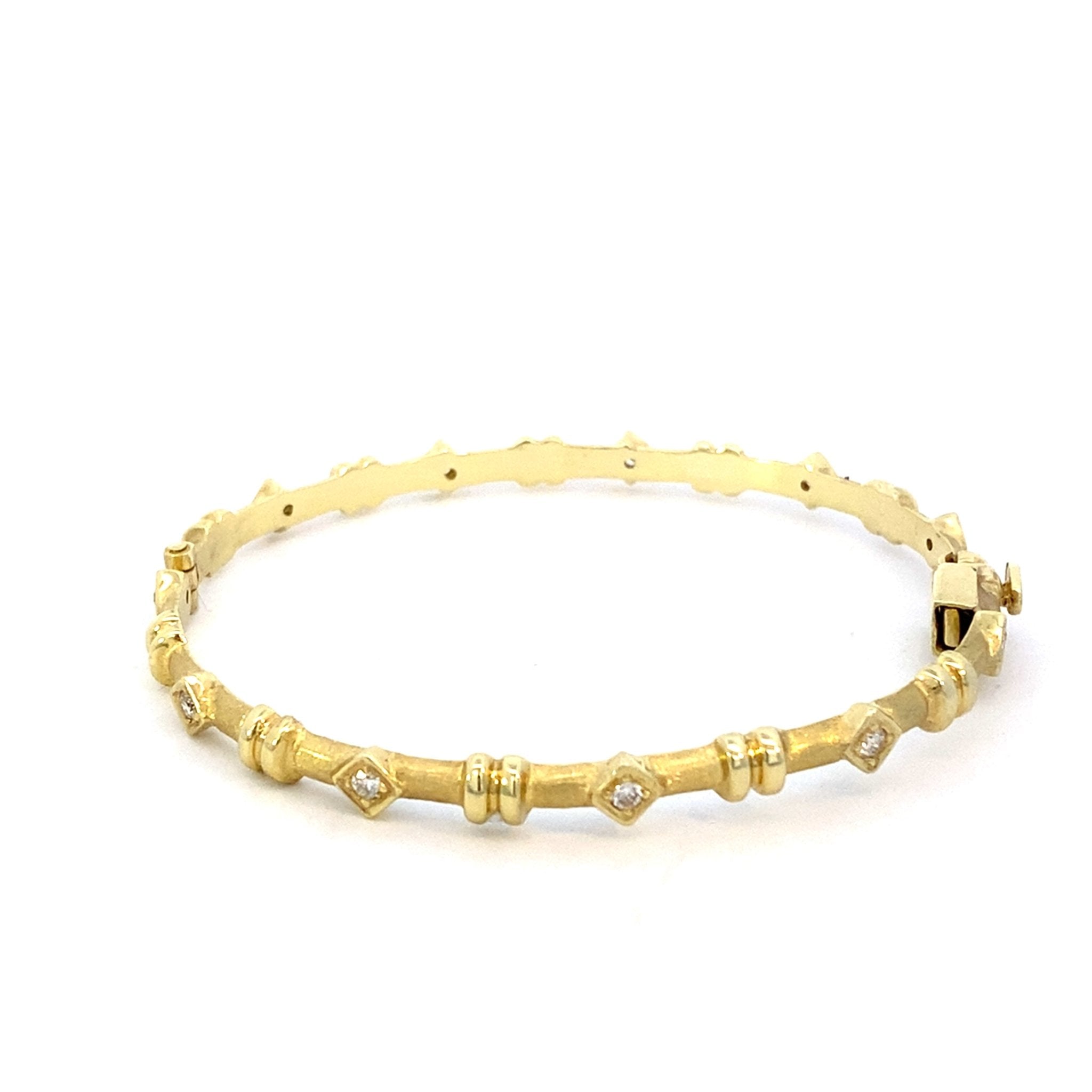 Bracelet designed as a hinged bangle set with diamonds in texture 14kt yellow gold - Gaines Jewelers