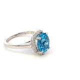 Ring- blue topaz set in a scalloped halo 14kt white gold - Gaines Jewelers