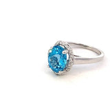 Ring- blue topaz set in a scalloped halo 14kt white gold - Gaines Jewelers