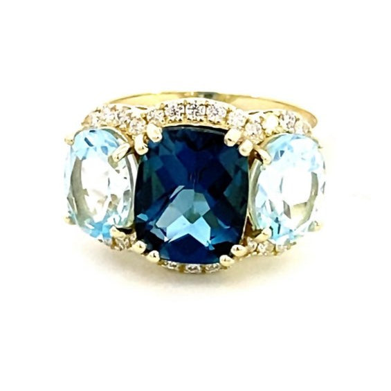 Ring designed with London blue topaz flanked by Sky blue with diamond halo 14kt yellow gold - Gaines Jewelers