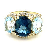 Ring designed with London blue topaz flanked by Sky blue with diamond halo 14kt yellow gold - Gaines Jewelers