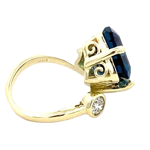 Ring in a bypass style set with a large London blue topaz 14kt yellow gold - Gaines Jewelers