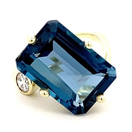 Ring in a bypass style set with a large London blue topaz 14kt yellow gold - Gaines Jewelers