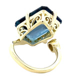 Ring in a bypass style set with a large London blue topaz 14kt yellow gold - Gaines Jewelers
