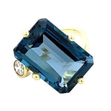 Ring in a bypass style set with a large London blue topaz 14kt yellow gold - Gaines Jewelers