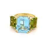 Ring set with a center blue topaz flanked by peridot 14kt yellow gold - Gaines Jewelers