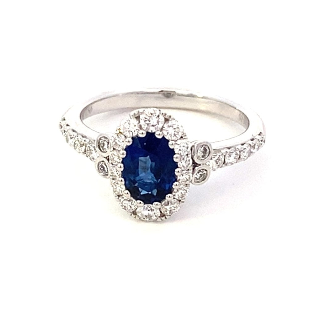 Ring with an oval sapphire, diamond halo and shank 18kt white gold - Gaines Jewelers