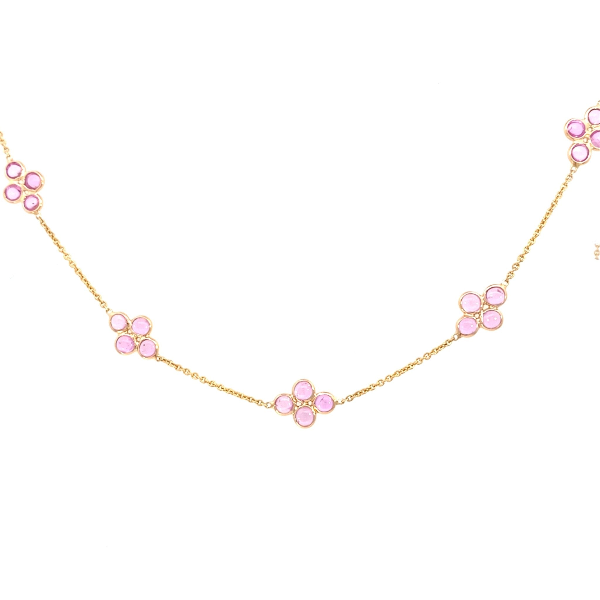 Station necklace with 4 bezel set round pink sapphires in 14kt yellow gold by Raymond Mazza - Gaines Jewelers