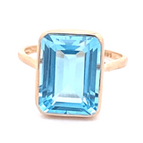Ring blue topaz emerald cut bezel - Gaines Jewelers