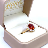 Ring set with a mandarin garnet surrounded by diamonds 14kt yellow gold by Rego