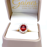 Ring set with a mandarin garnet surrounded by diamonds 14kt yellow gold by Rego