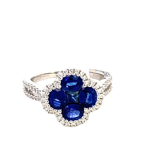 Ring set with 5 sapphires is a cluster surrounded by a diamond halo and shank 18kt white gold