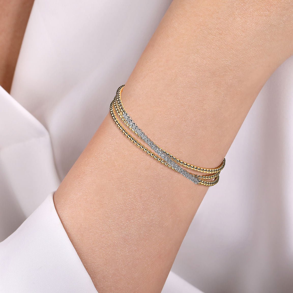 Bracelet flex cuff with 3 overlapping rows & 1 has diamonds 2 - tone karat gold - Gaines Jewelers