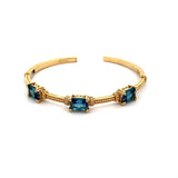 Cuff bangle bracelet with 3 emerald London blue topaz 14kt yellow gold - Gaines Jewelers