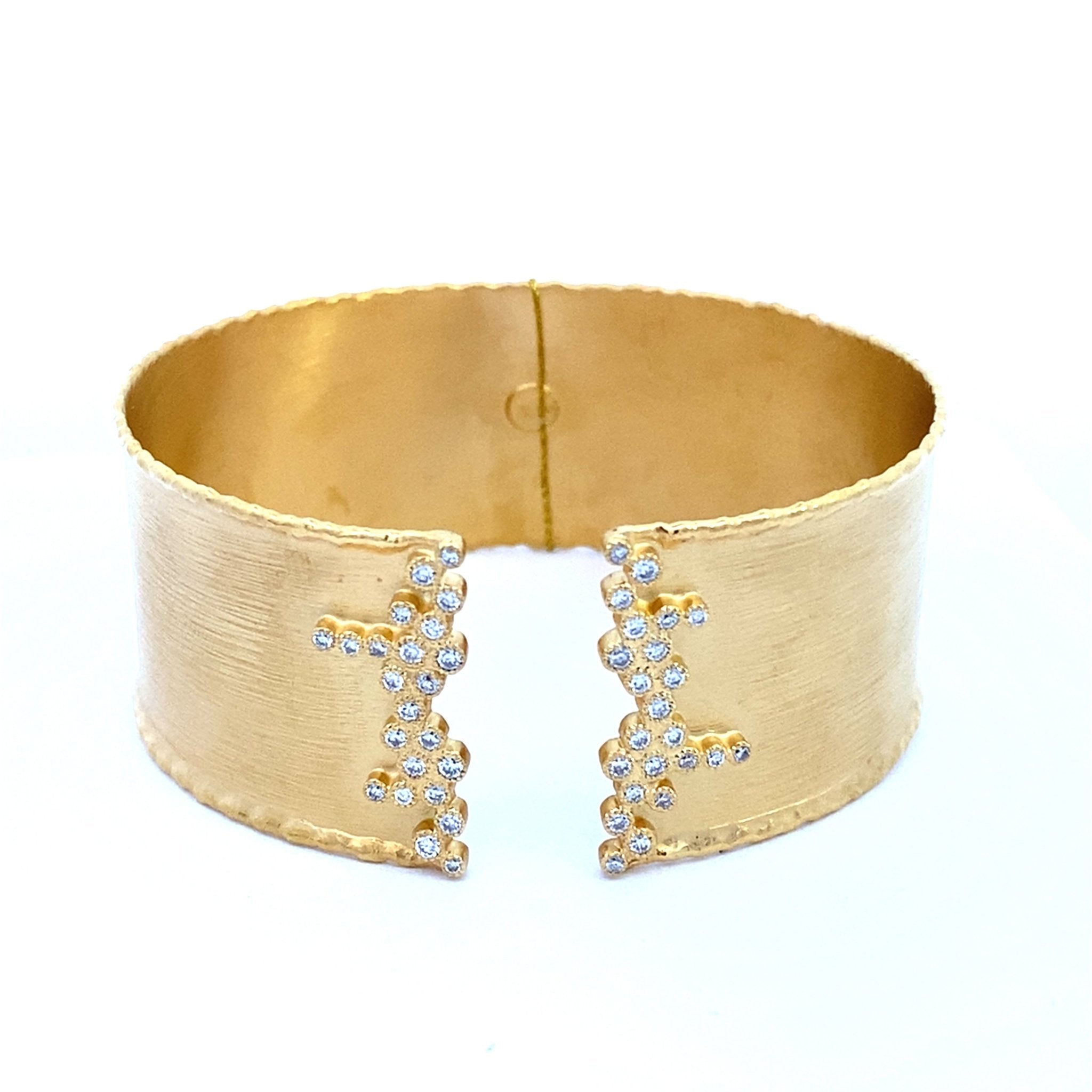 Cuff bracelet with a split top edged with diamonds in 14kt yellow gold by Marika - Gaines Jewelers