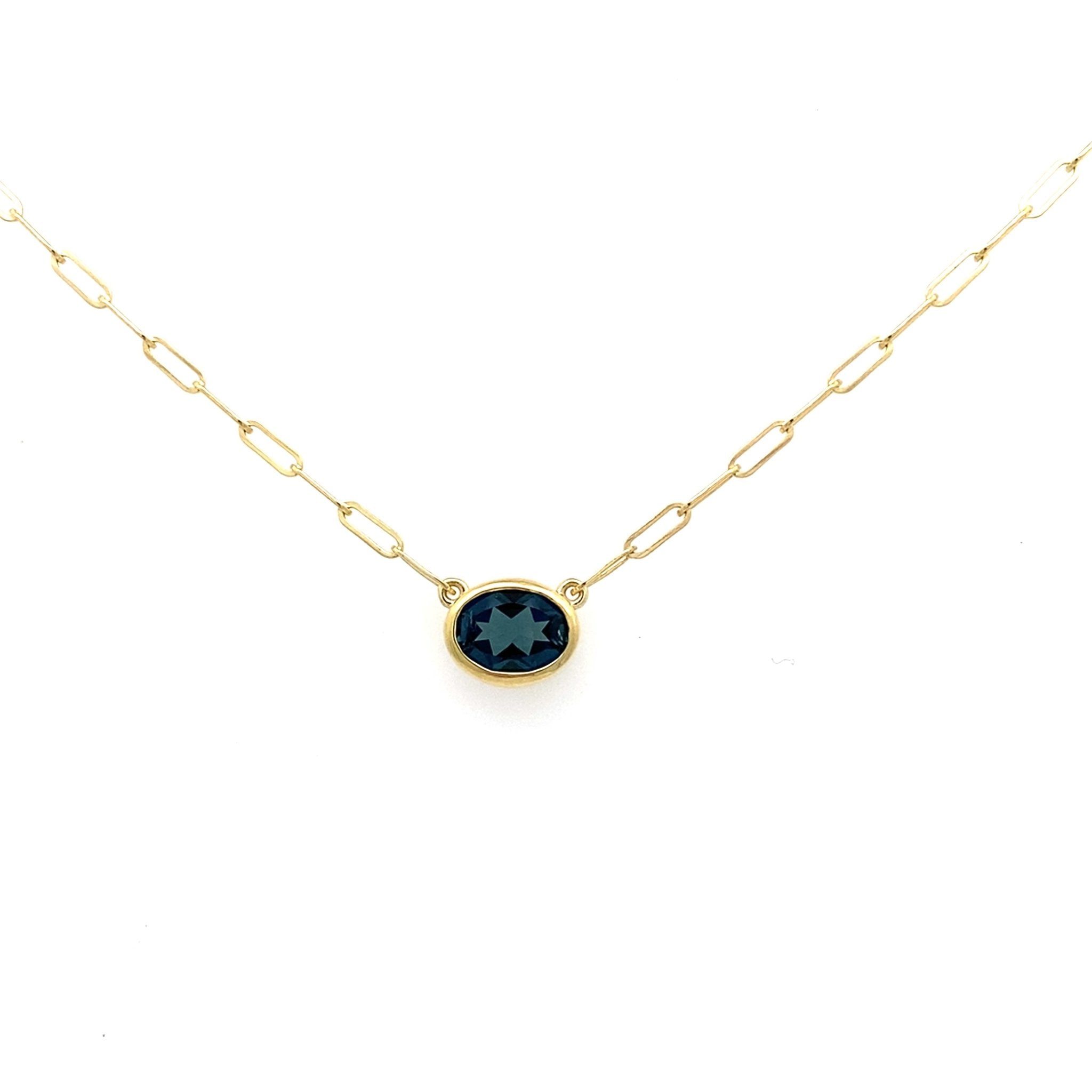 Pendant with a blue topaz on a paperclip chain 14kt yellow gold by Raymond Mazza - Gaines Jewelers