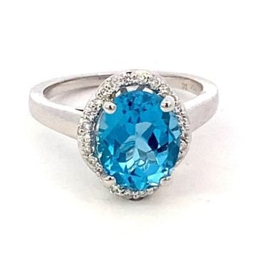 Ring- blue topaz set in a scalloped halo 14kt white gold - Gaines Jewelers