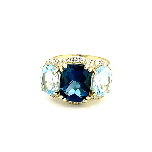 Ring designed with London blue topaz flanked by Sky blue with diamond halo 14kt yellow gold - Gaines Jewelers