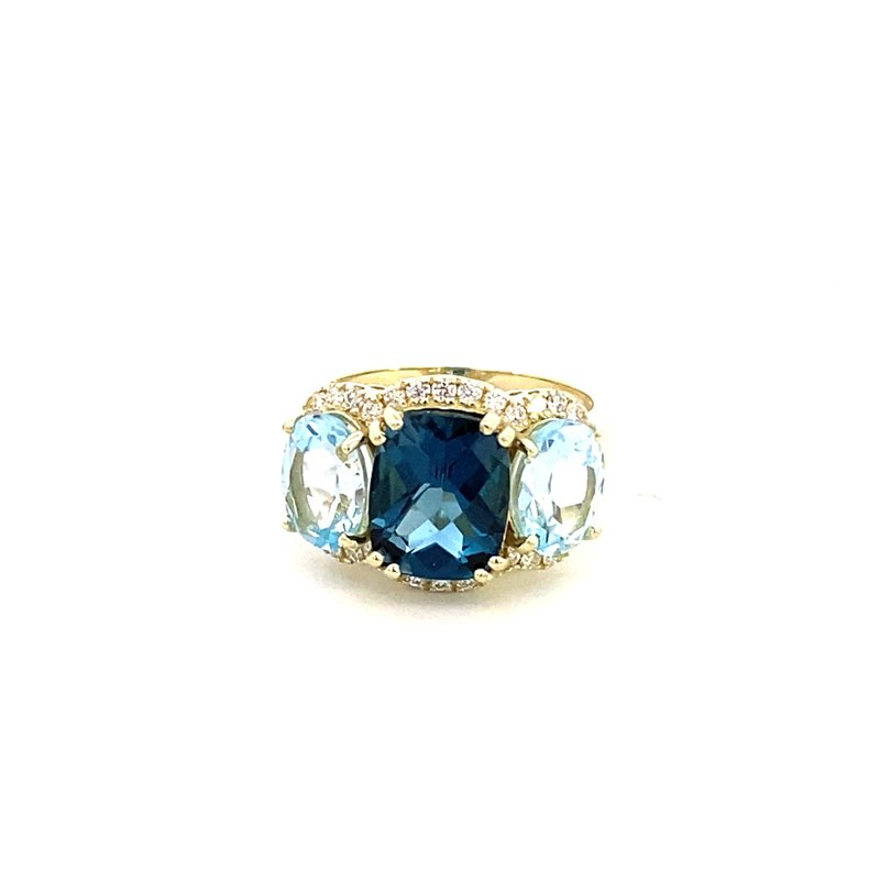 Ring designed with London blue topaz flanked by Sky blue with diamond halo 14kt yellow gold - Gaines Jewelers