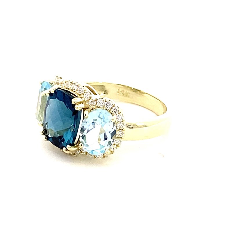 Ring designed with London blue topaz flanked by Sky blue with diamond halo 14kt yellow gold - Gaines Jewelers