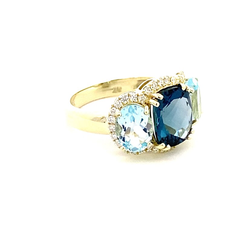 Ring designed with London blue topaz flanked by Sky blue with diamond halo 14kt yellow gold - Gaines Jewelers