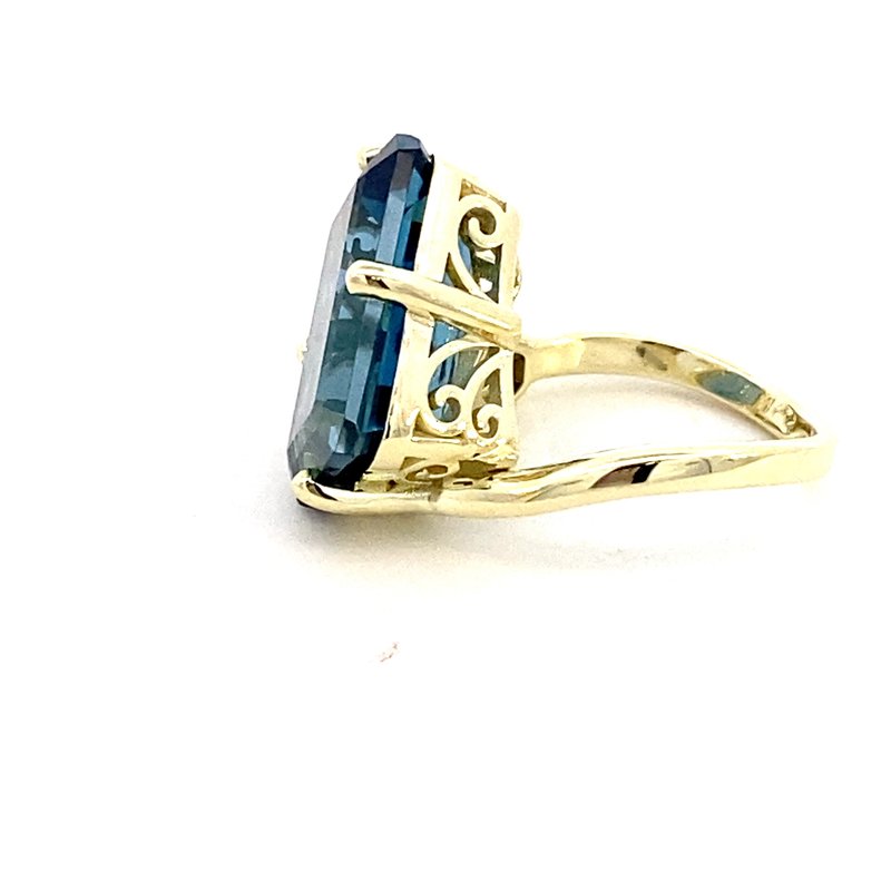 Ring in a bypass style set with a large London blue topaz 14kt yellow gold - Gaines Jewelers