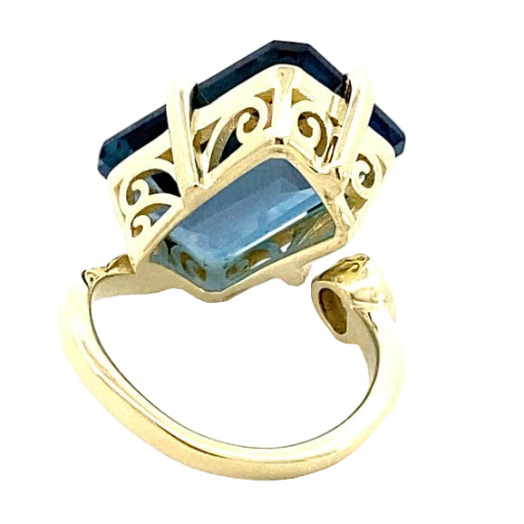 Ring in a bypass style set with a large London blue topaz 14kt yellow gold - Gaines Jewelers