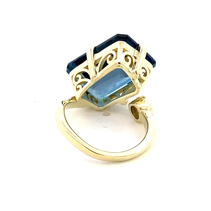 Ring in a bypass style set with a large London blue topaz 14kt yellow gold - Gaines Jewelers