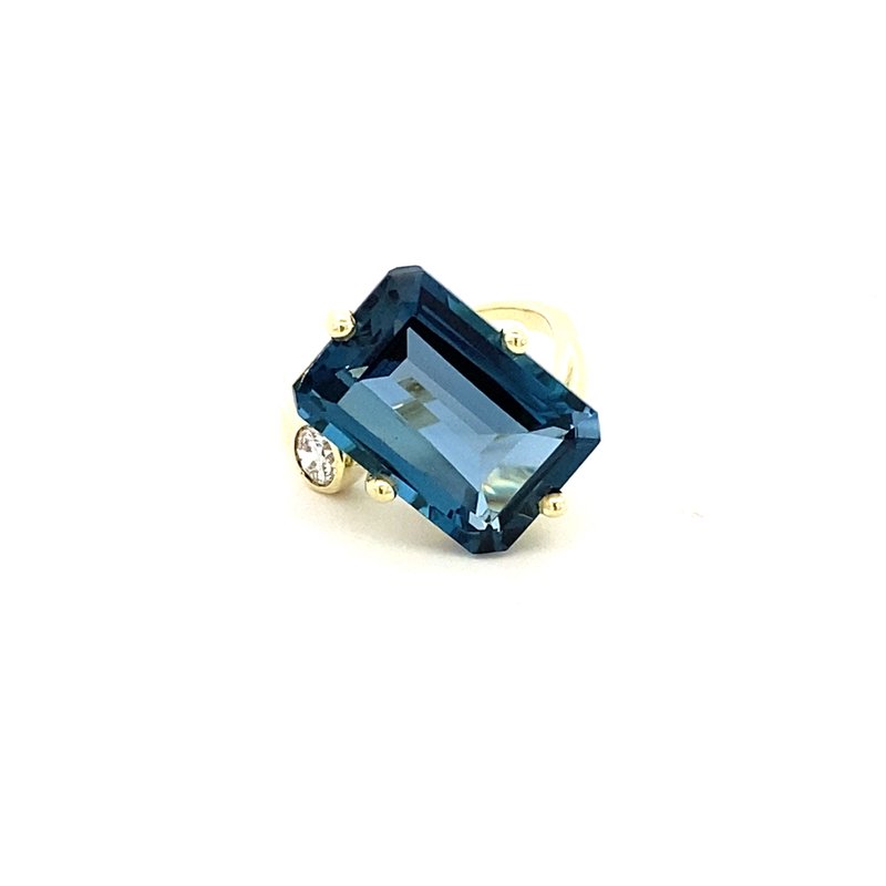 Ring in a bypass style set with a large London blue topaz 14kt yellow gold - Gaines Jewelers