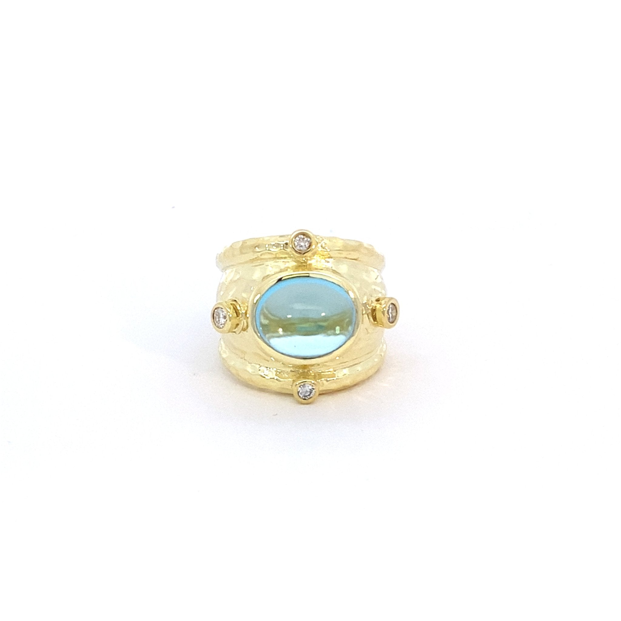 Ring set with a blue topaz & accented with diamonds, wide, in 14kt yellow gold by Raymond Mazza - Gaines Jewelers