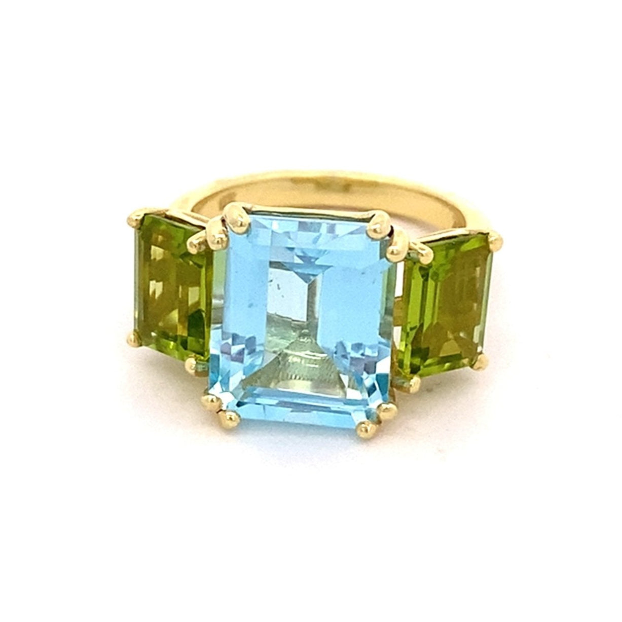 Ring set with a center blue topaz flanked by peridot 14kt yellow gold - Gaines Jewelers