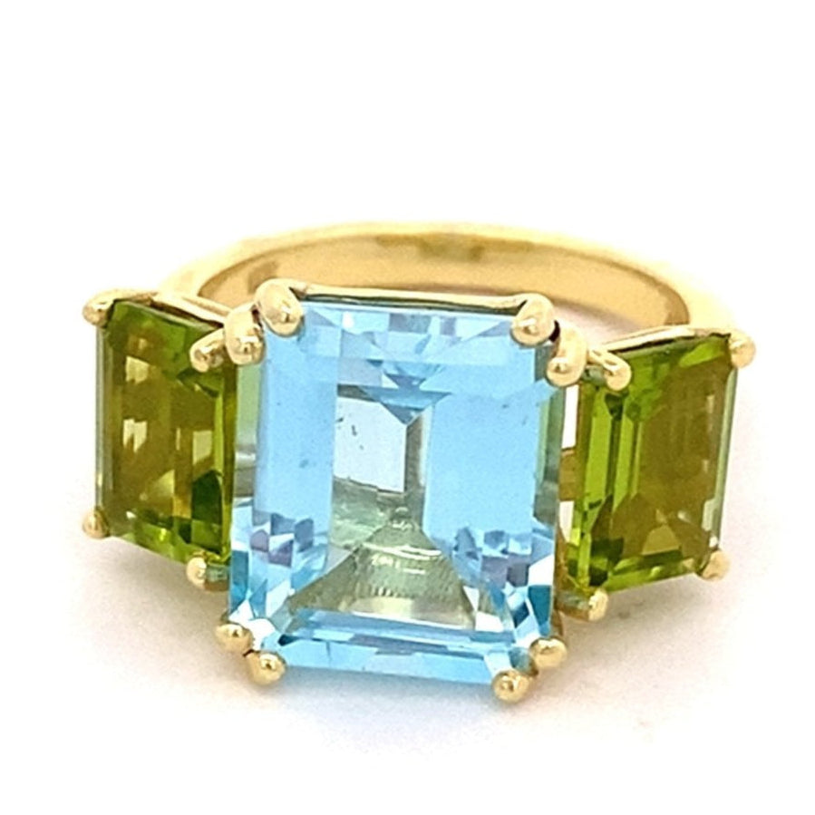Ring set with a center blue topaz flanked by peridot 14kt yellow gold - Gaines Jewelers