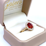 Ring set with a mandarin garnet surrounded by diamonds 14kt yellow gold by Rego - Gaines Jewelers