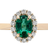 Ring set with an oval emerald surrounded by a diamond halo 14kt yellow gold - Gaines Jewelers