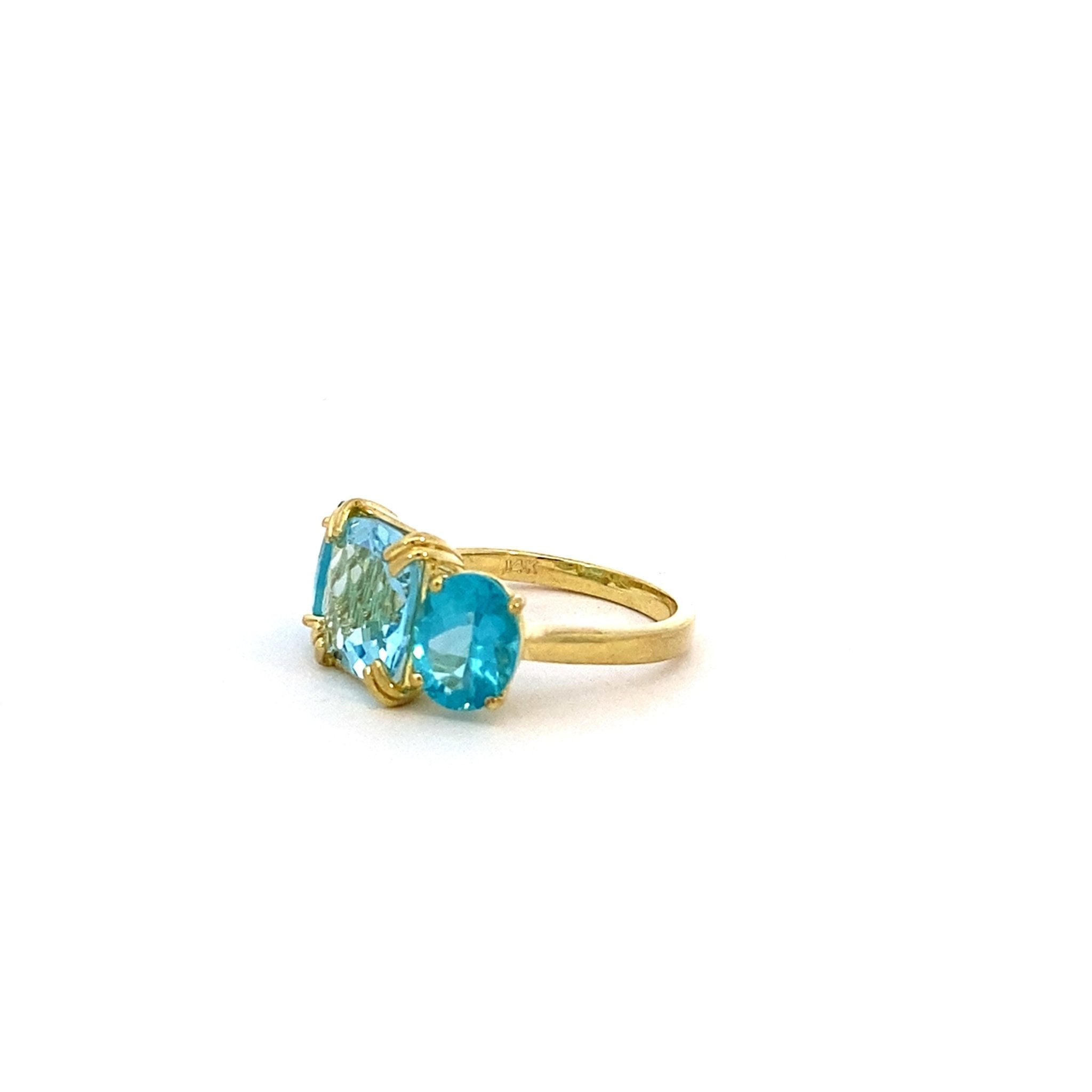 Three-stone ring set with blue topaz & appatite in 14kt yellow gold by Raymond Mazza - Gaines Jewelers