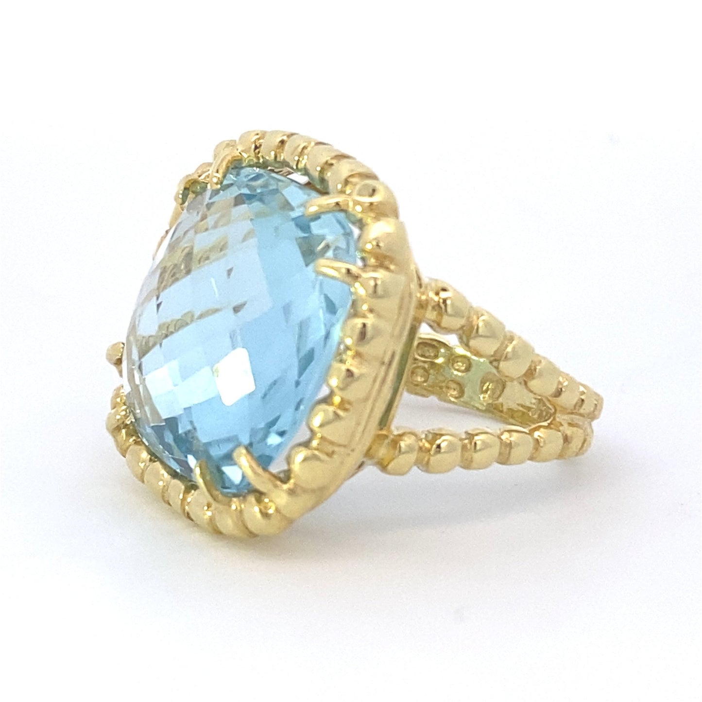 Ring blue topaz cushion with braided halo and shank - Gaines Jewelers